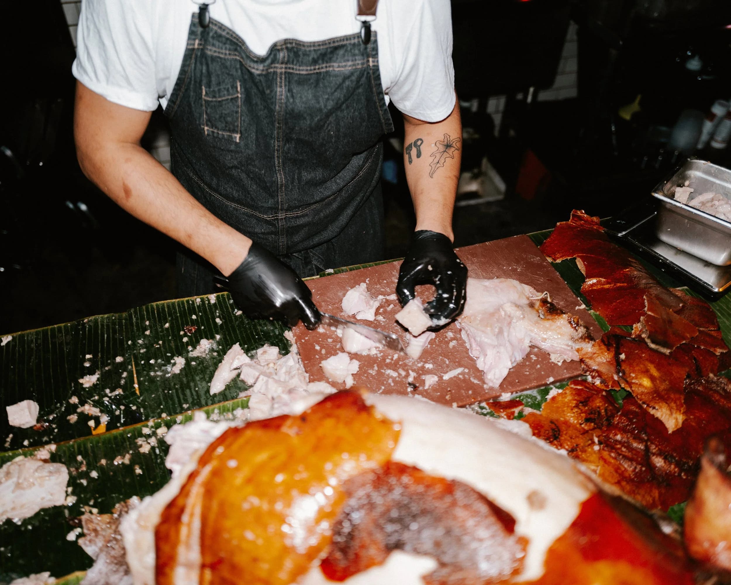 Chef TJ Cruz preparing lechon at the 5-year anniversary
